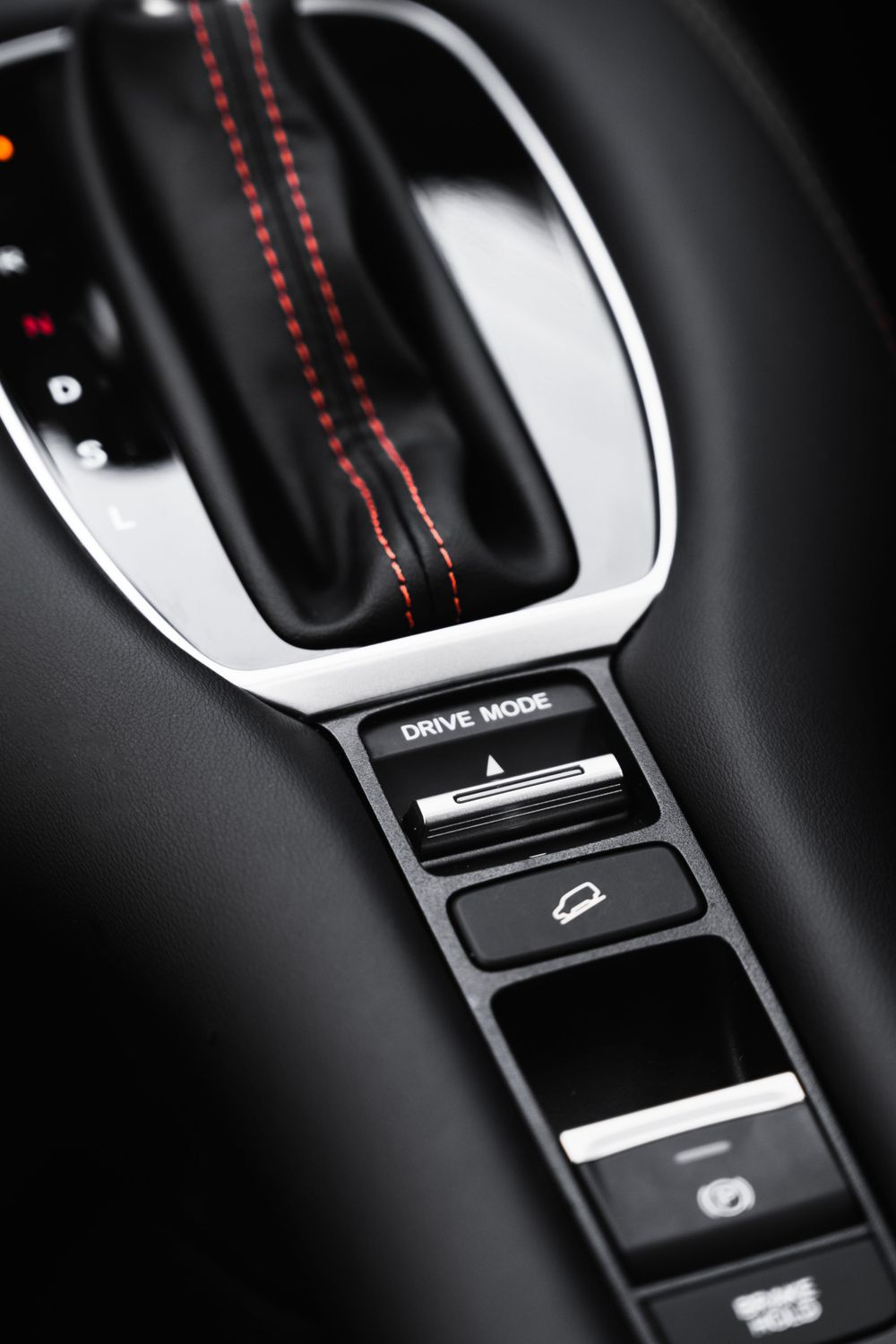 Center console showing drive mode selector and control buttons with red stitching detail.Mtlshutter photography