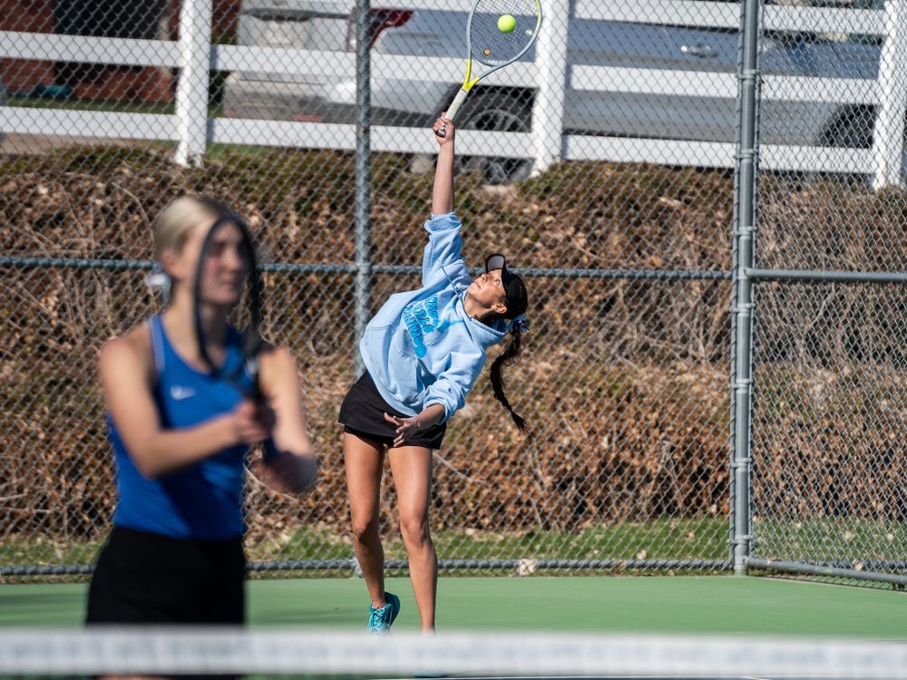 Two tennis players during a competitive match on an outdoor court.