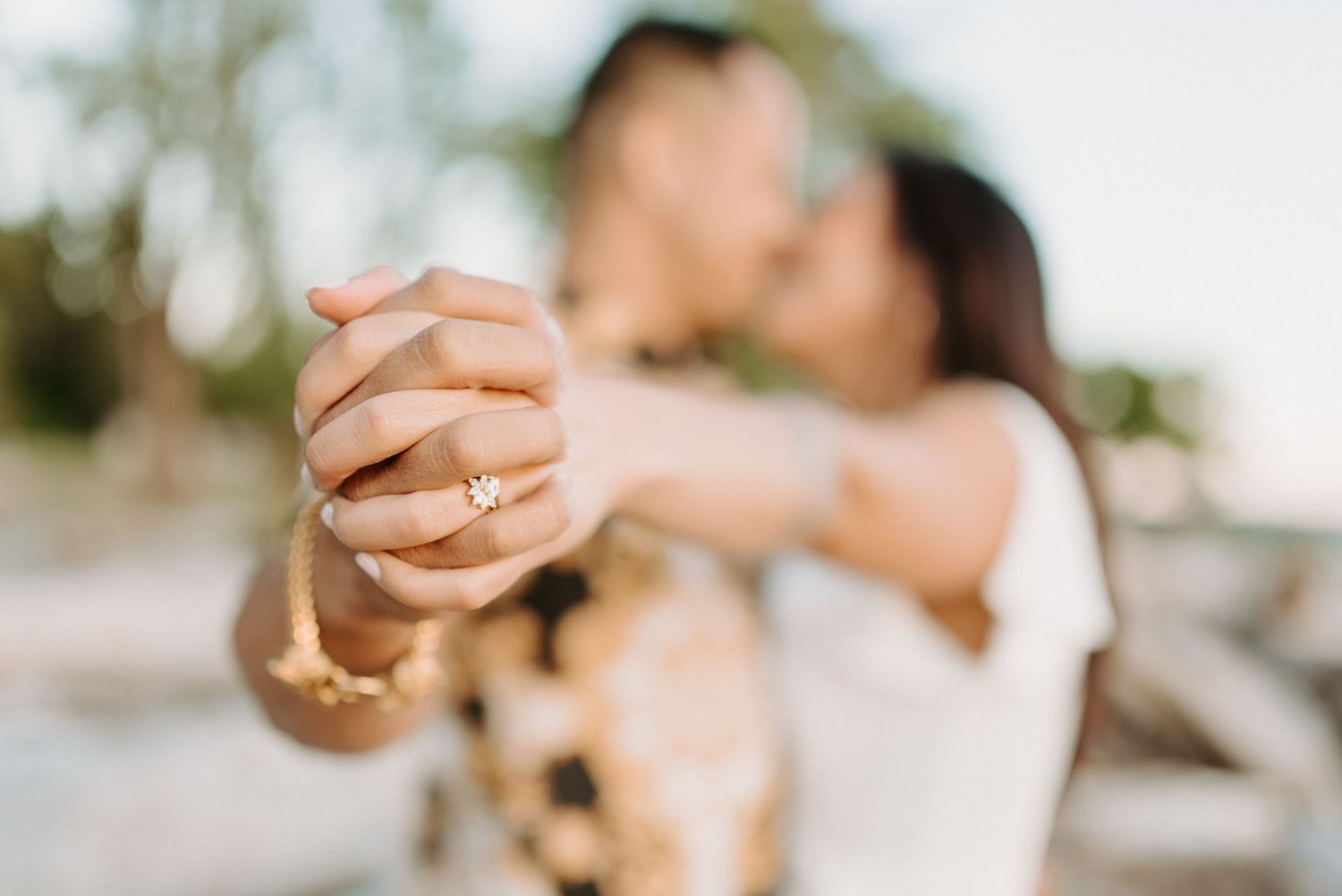 Close-up shot of clasped hands during a romantic dance at sunset.