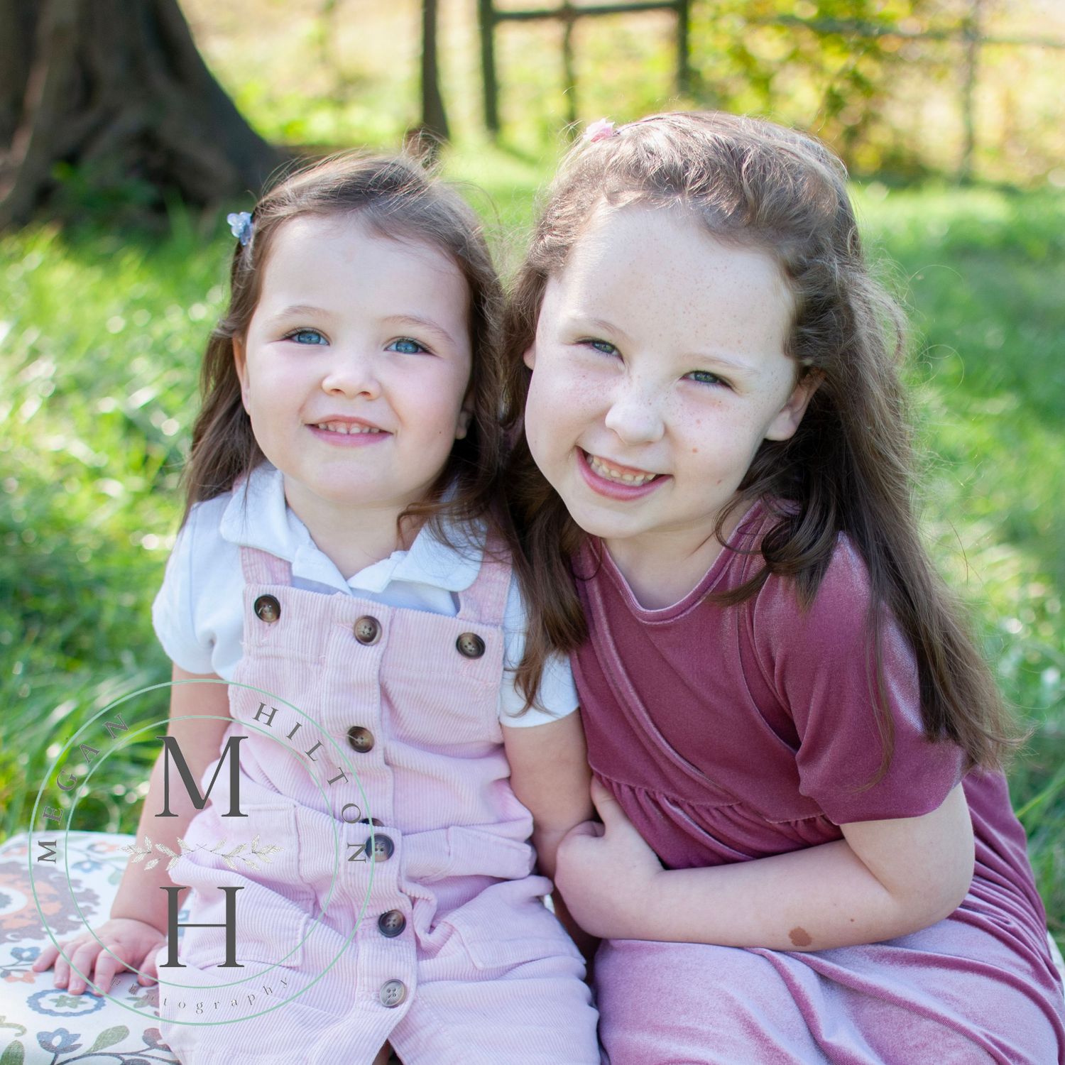 two girls sitting together photo