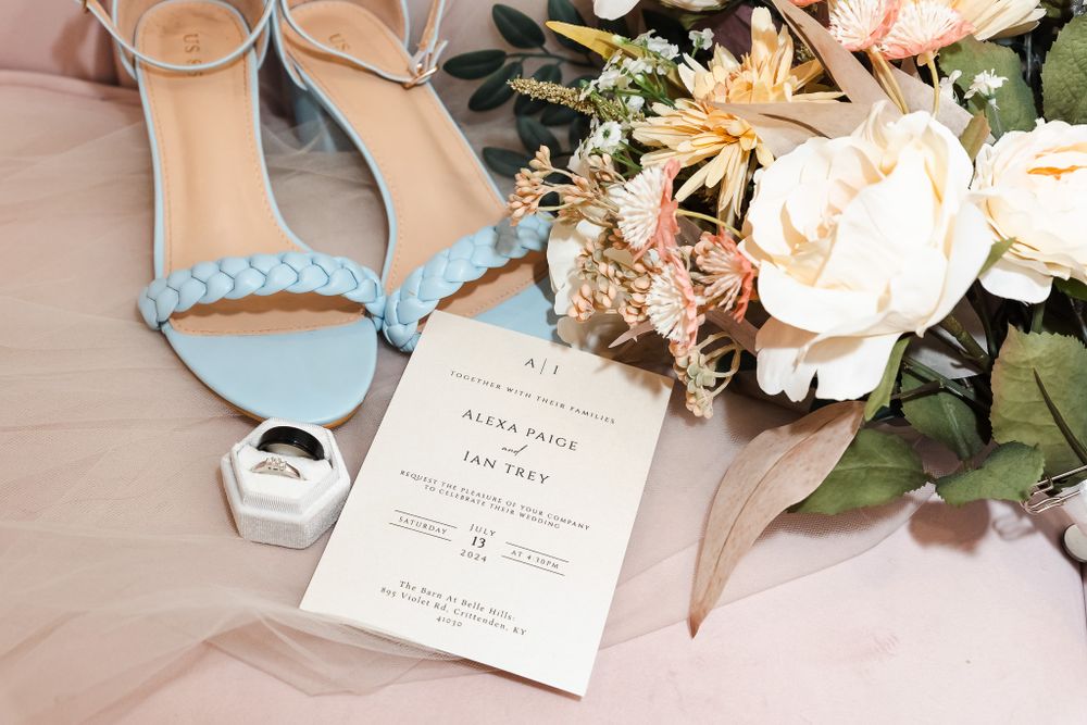 Elegant wedding details with floral arrangements and invitation cards in soft pastel tones.