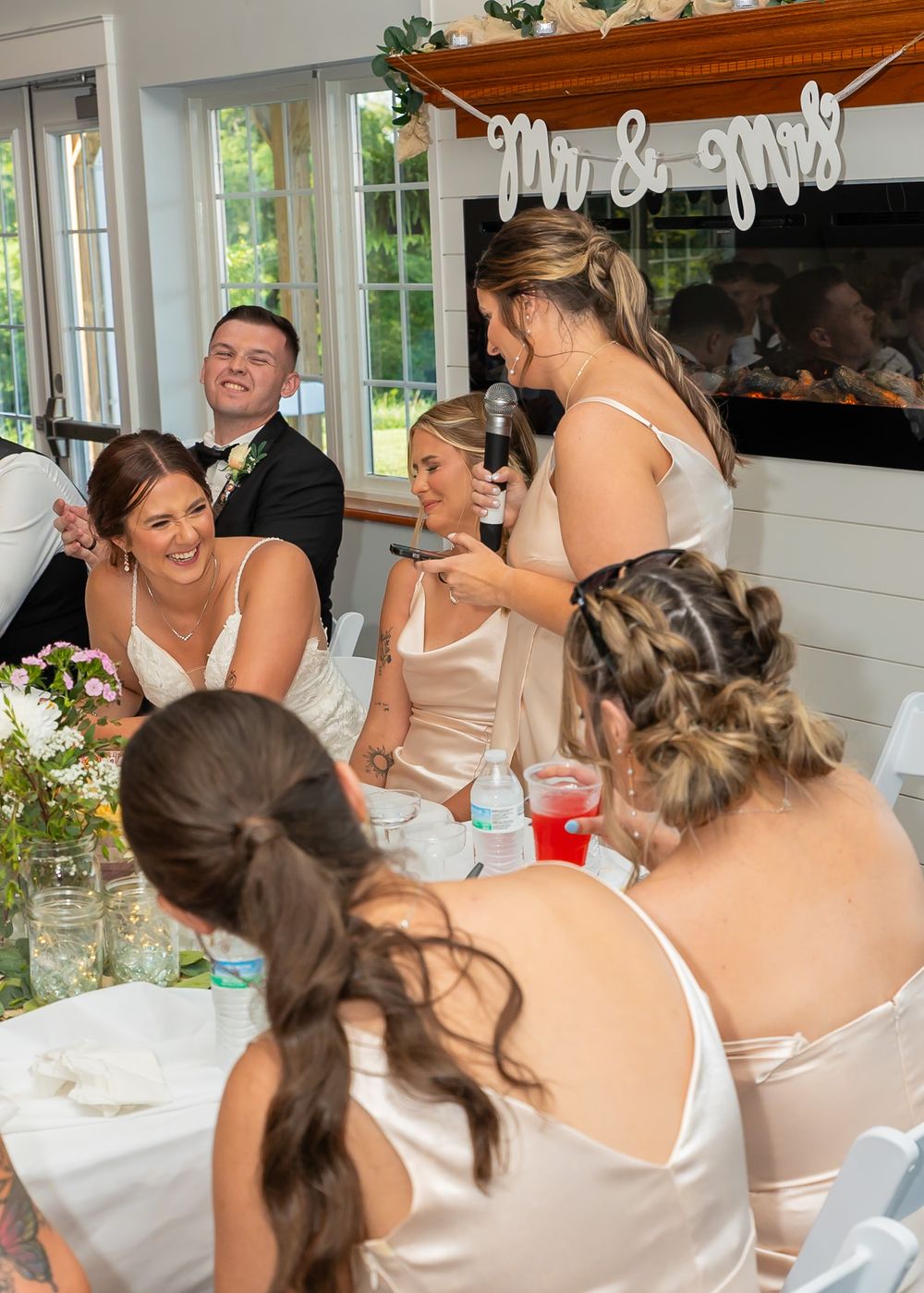 Wedding reception scene with guests in formal attire enjoying a celebration.