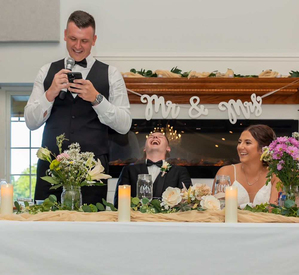 Wedding reception venue decorated with floral arrangements and 'Mr & Mrs' signage.
