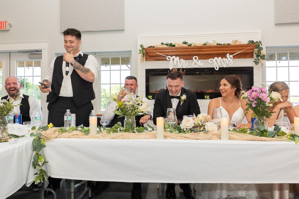 Wedding reception tables adorned with floral arrangements and decorative elements.