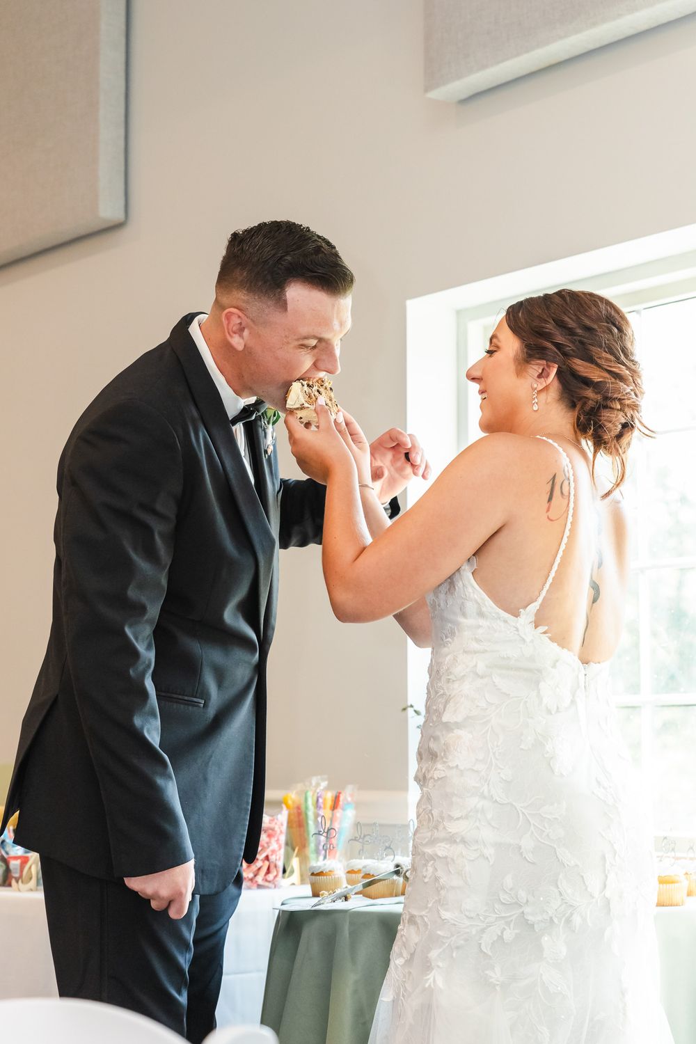 Wedding celebration in a bright indoor venue with formal attire.