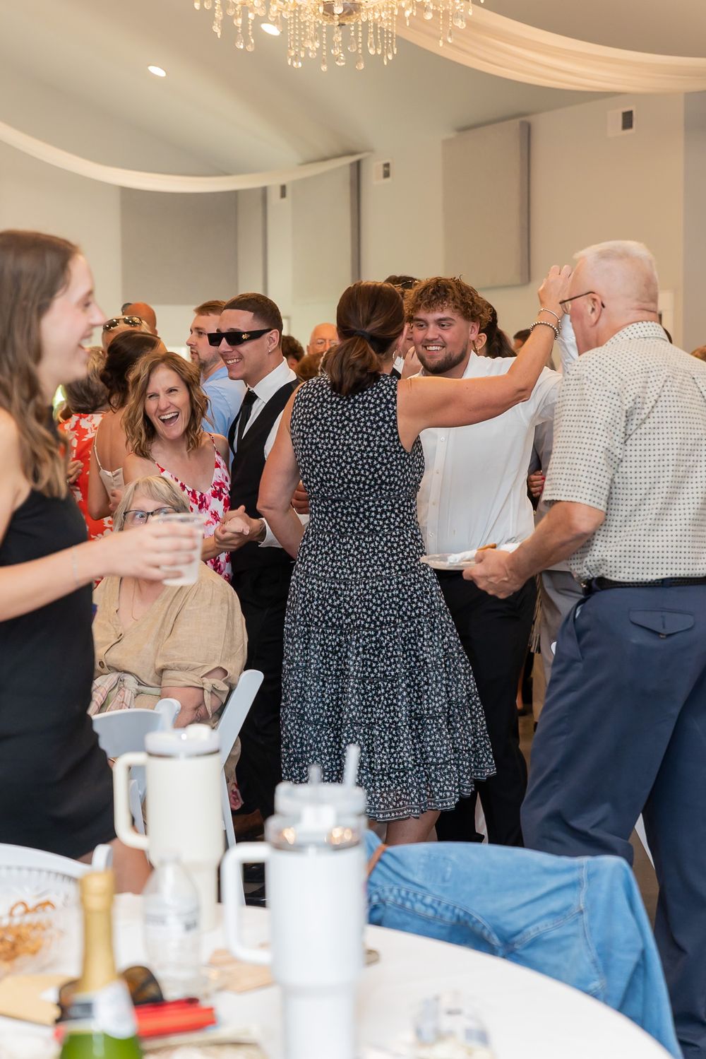 Lively wedding reception with guests dancing and celebrating.