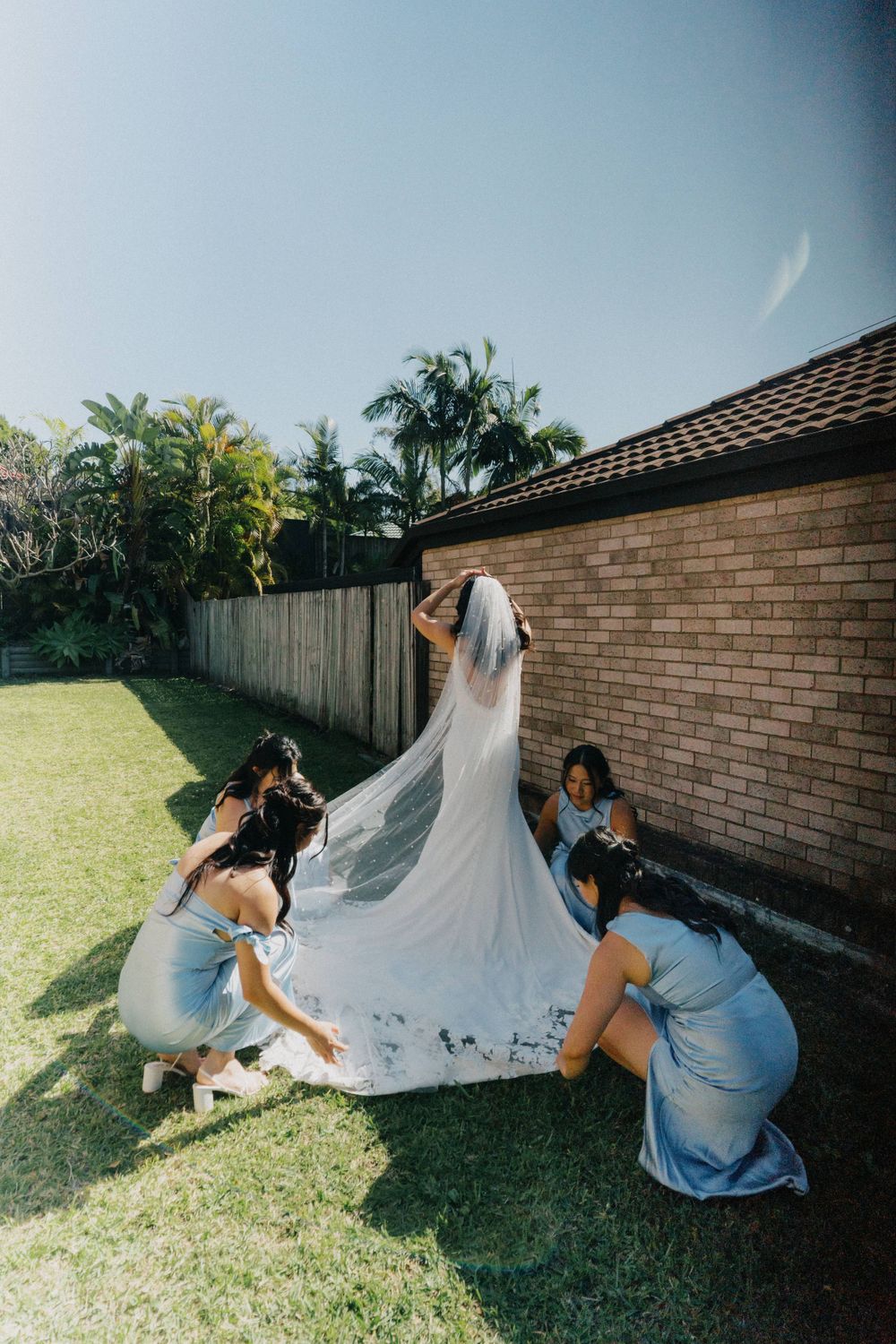 Bride putting on her veil before the ceremony at The Refinery, captured in a documentary, candid style.”