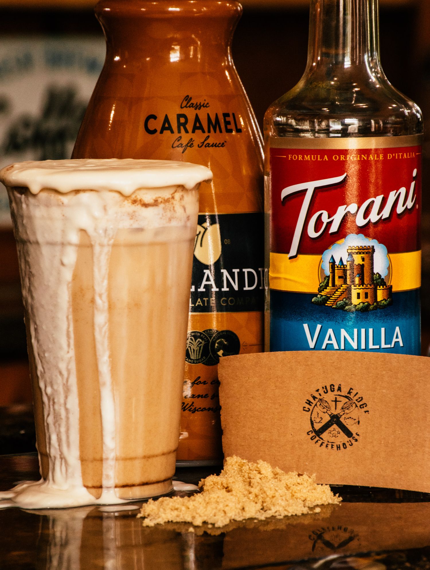 Coffee drinks with vanilla syrup and caramel toppings in tall glasses.