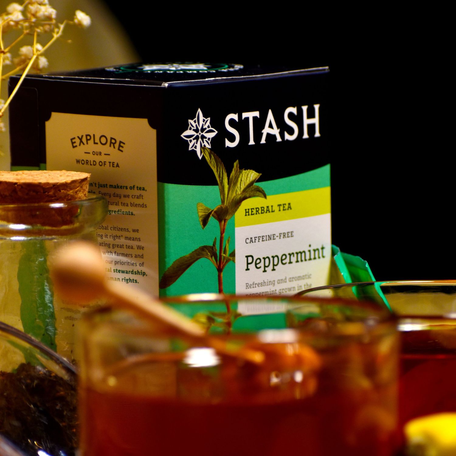 Stash brand tea boxes arranged on a dark background with warm lighting.