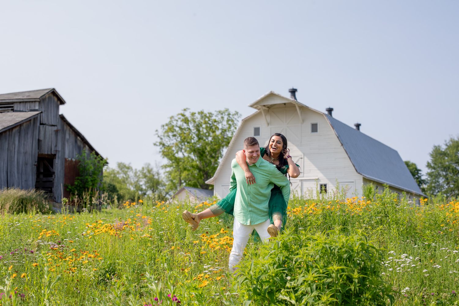 Couple session at Cincinnati farm wildflower field with luxury styling and professional outdoor portraits for high-end clients with barn