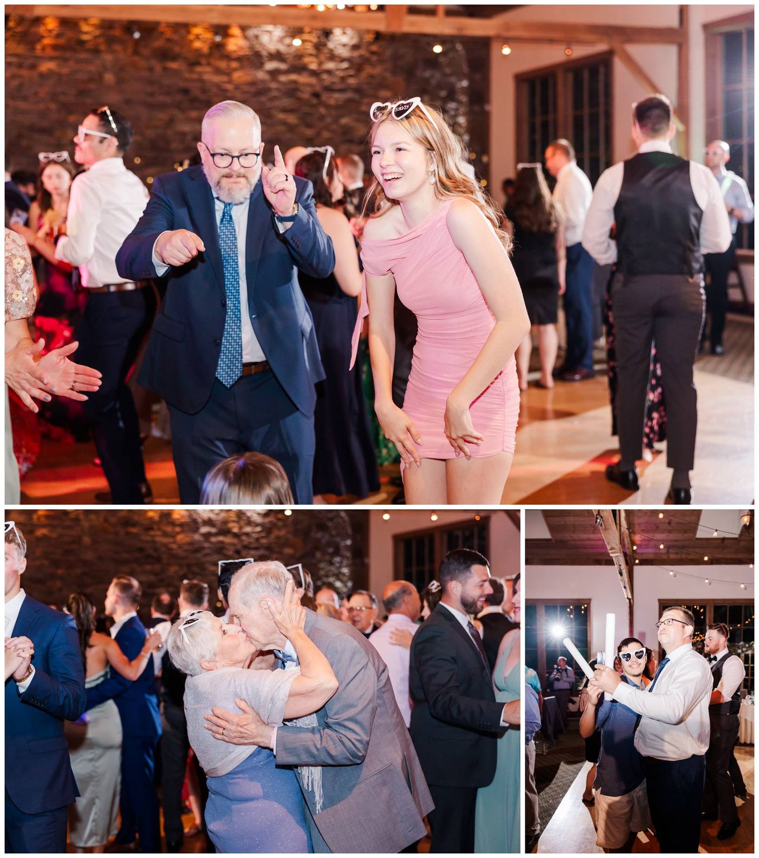 Wedding guests dancing enthusiastically at reception in rustic venue with brick walls and ambient lighting.