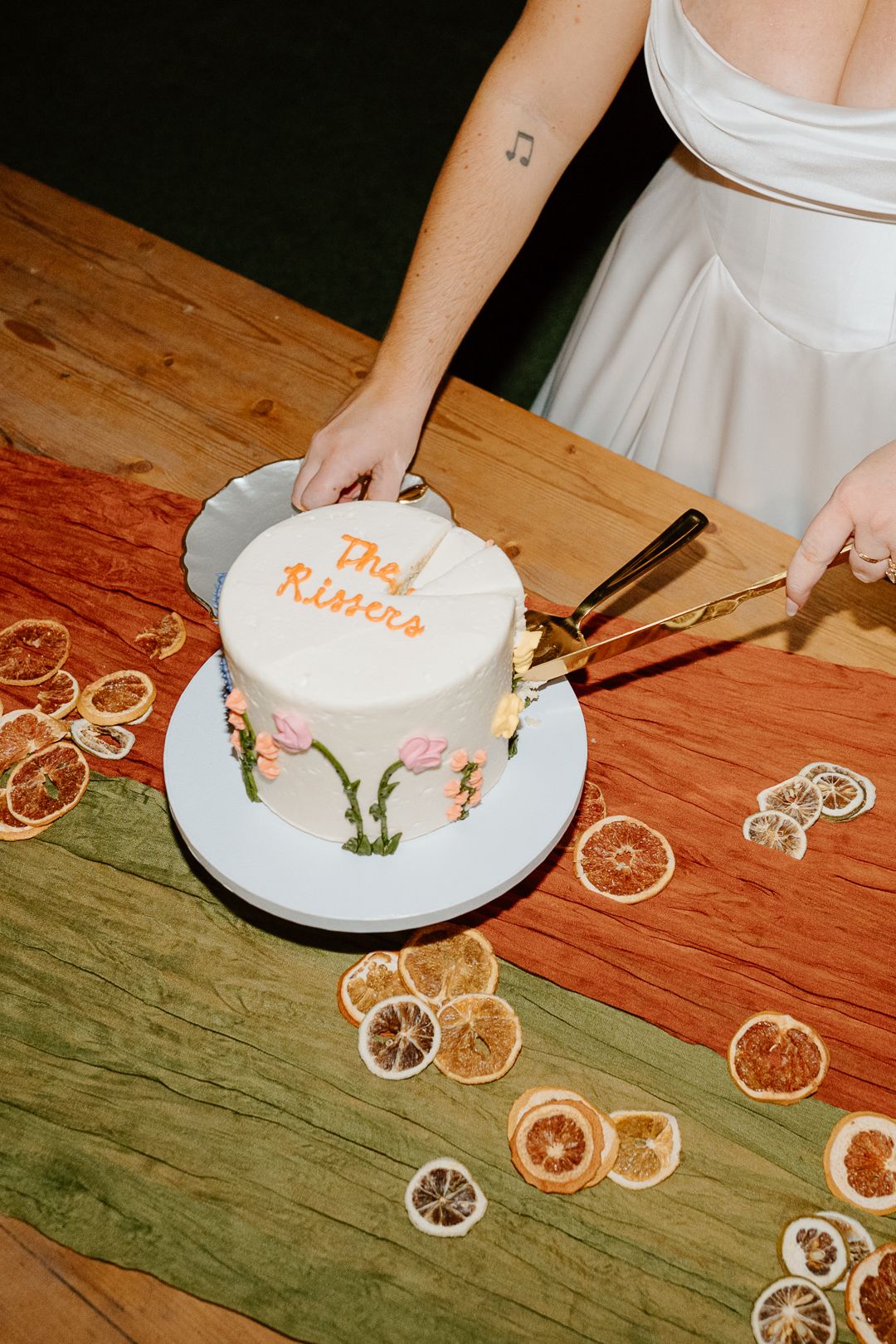 A classic white tiered wedding cake decorated with delicate floral arrangements and baby's breath on display.