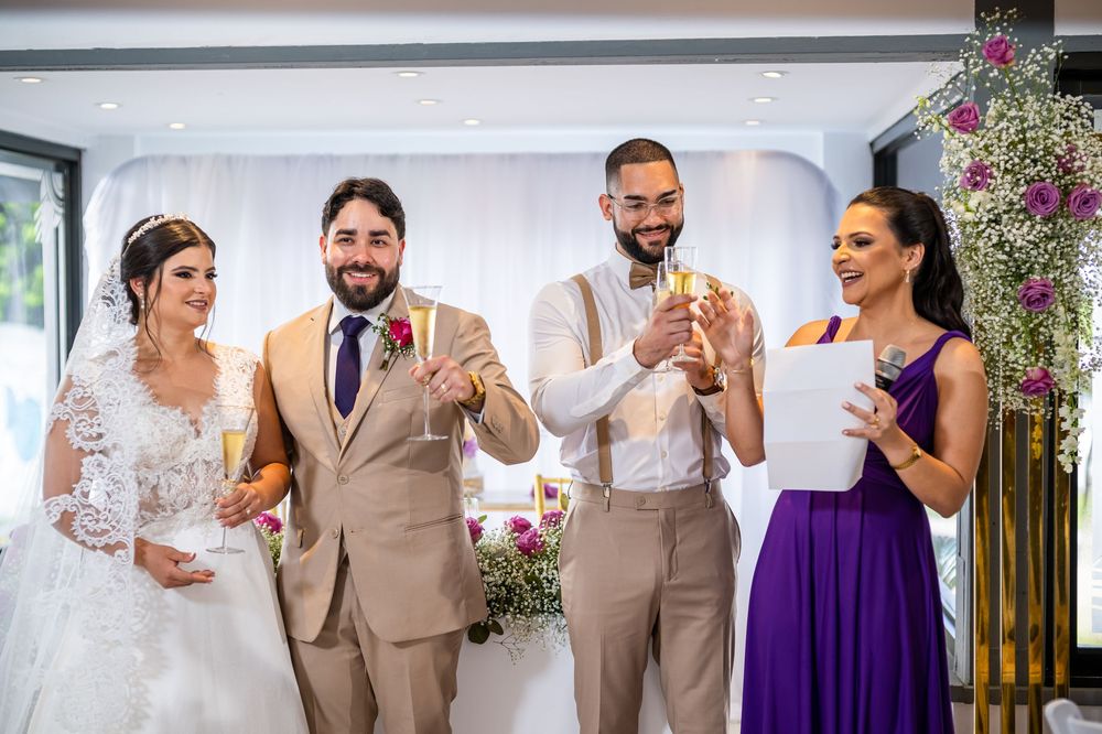 Wedding party toasting and celebrating during reception with floral decorations.