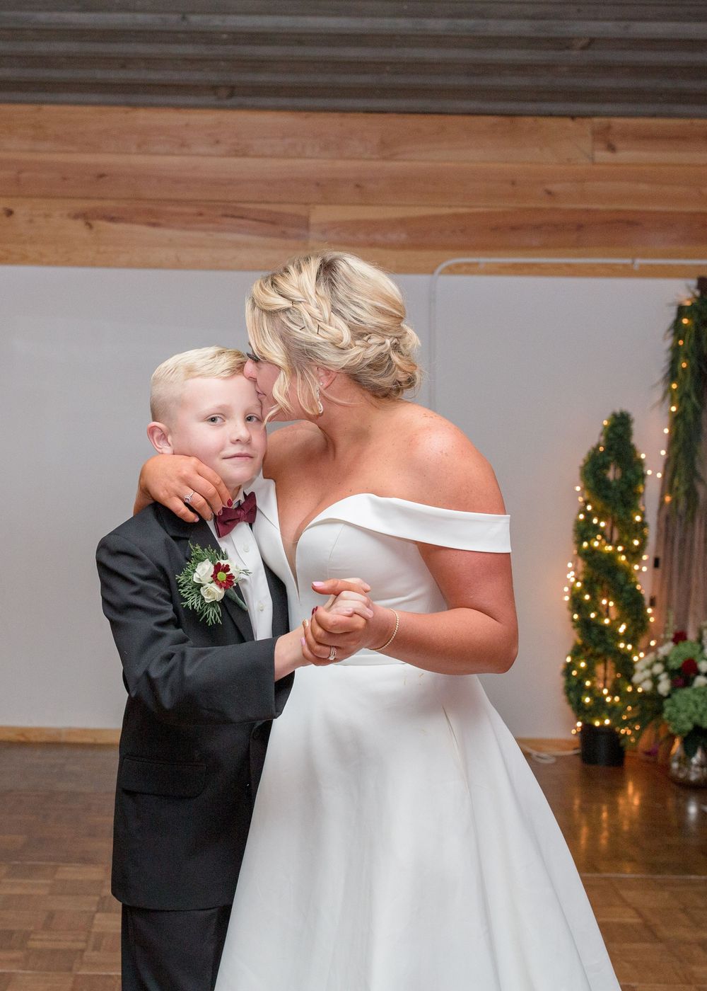 Mother and son sharing a joyful moment during their wedding day in North Carolina.