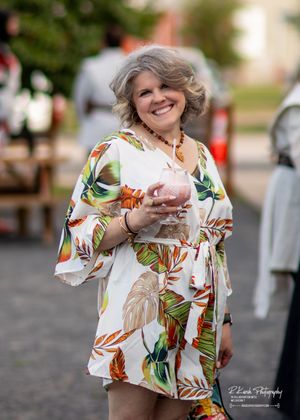 White blouse with colorful tropical floral print shown in multiple close-up shots outdoors.
