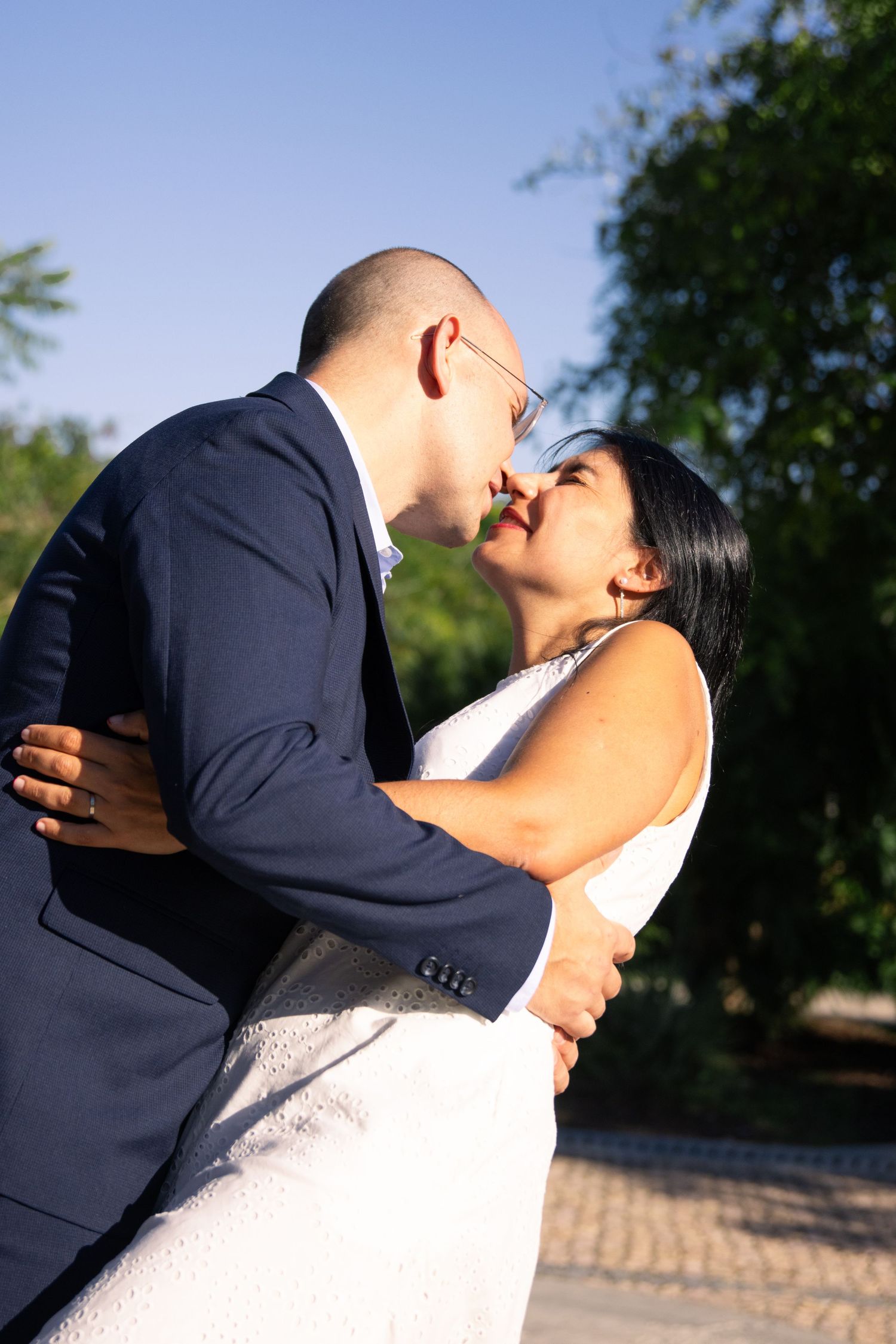 Intimate wedding portraits captured against natural outdoor backdrop.