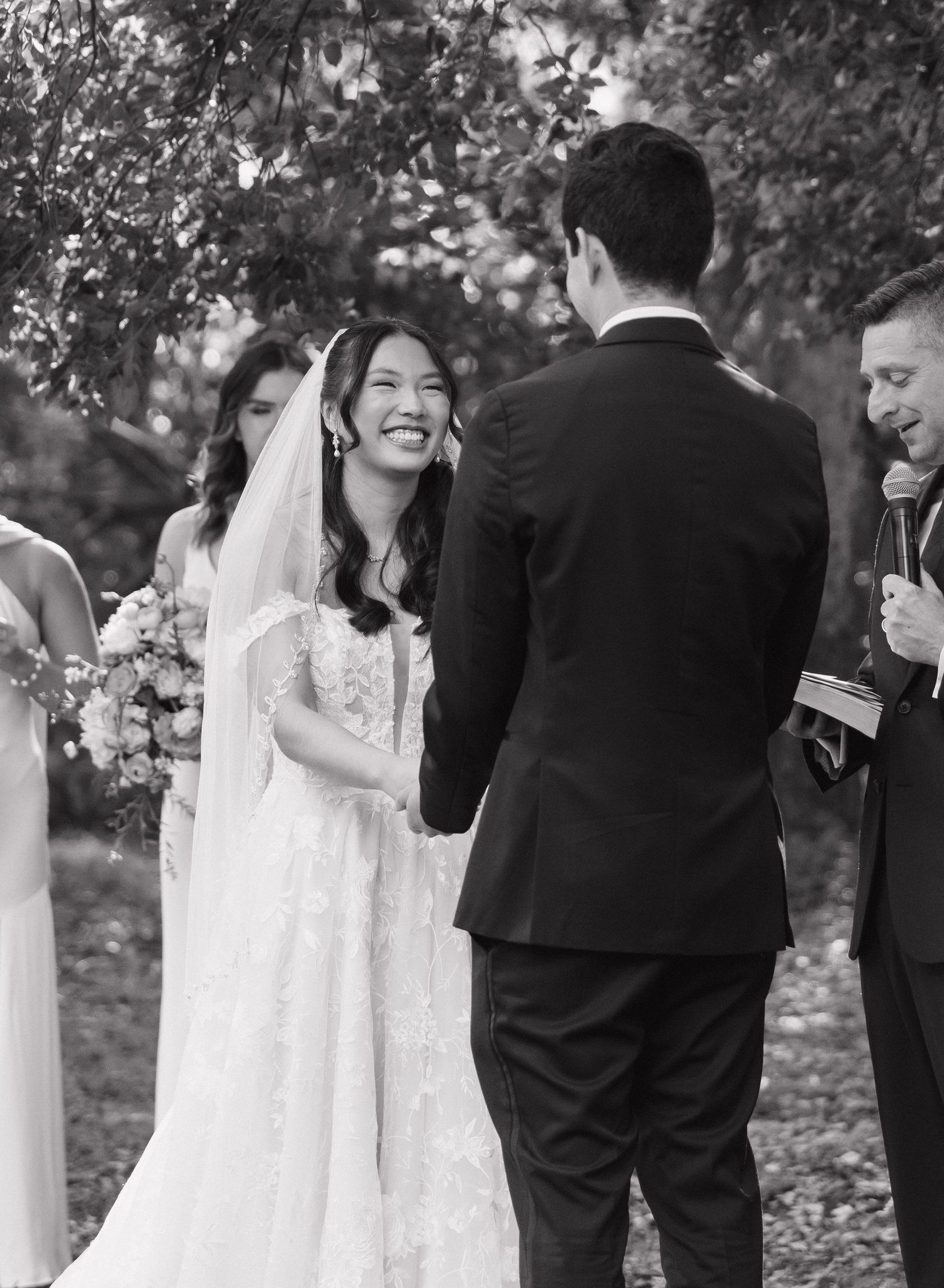 Black and white wedding ceremony photos showing couple exchanging vows in an outdoor garden setting.