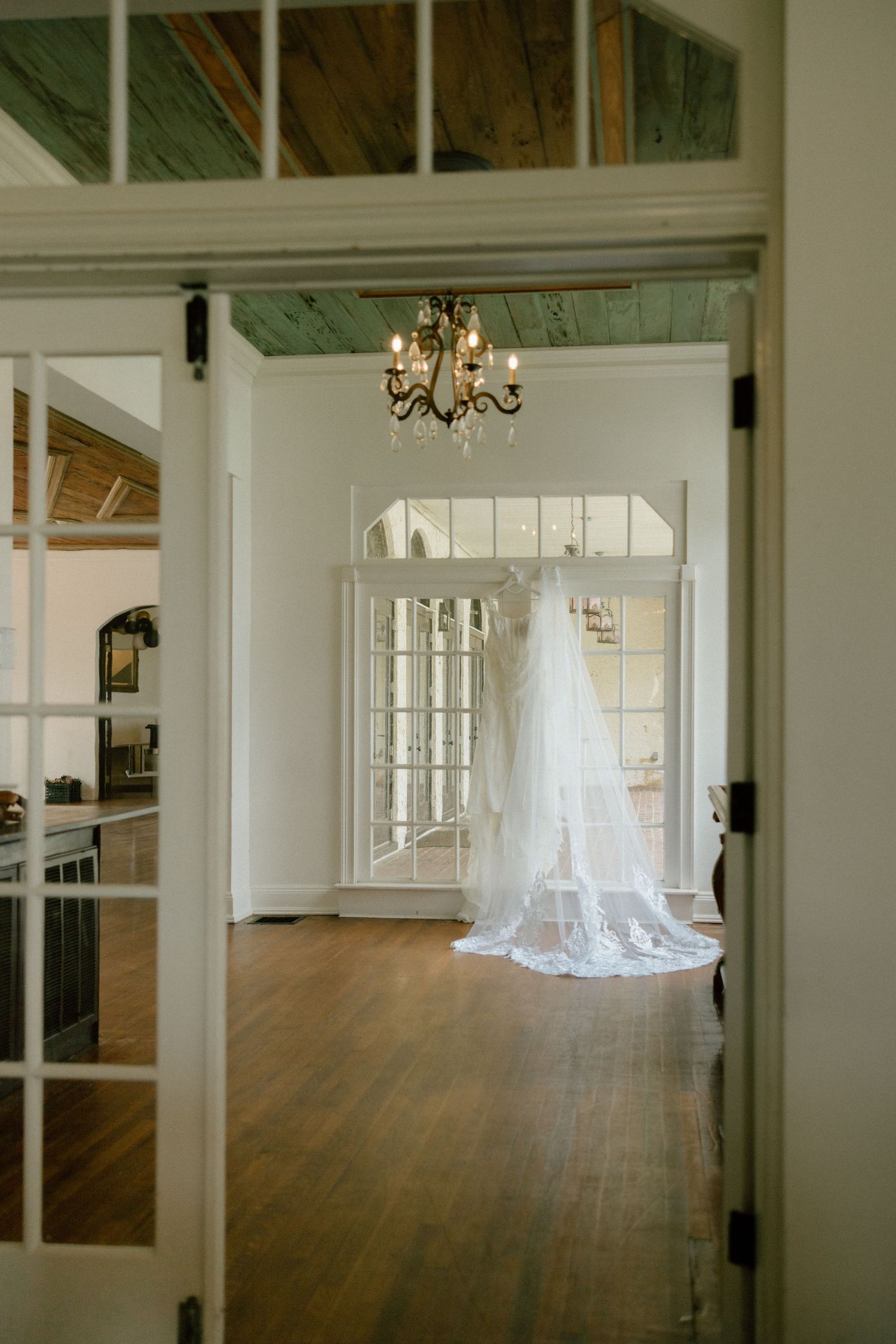 A series of interior shots showing an elegant white room with hardwood floors and a hanging chandelier in different angles.