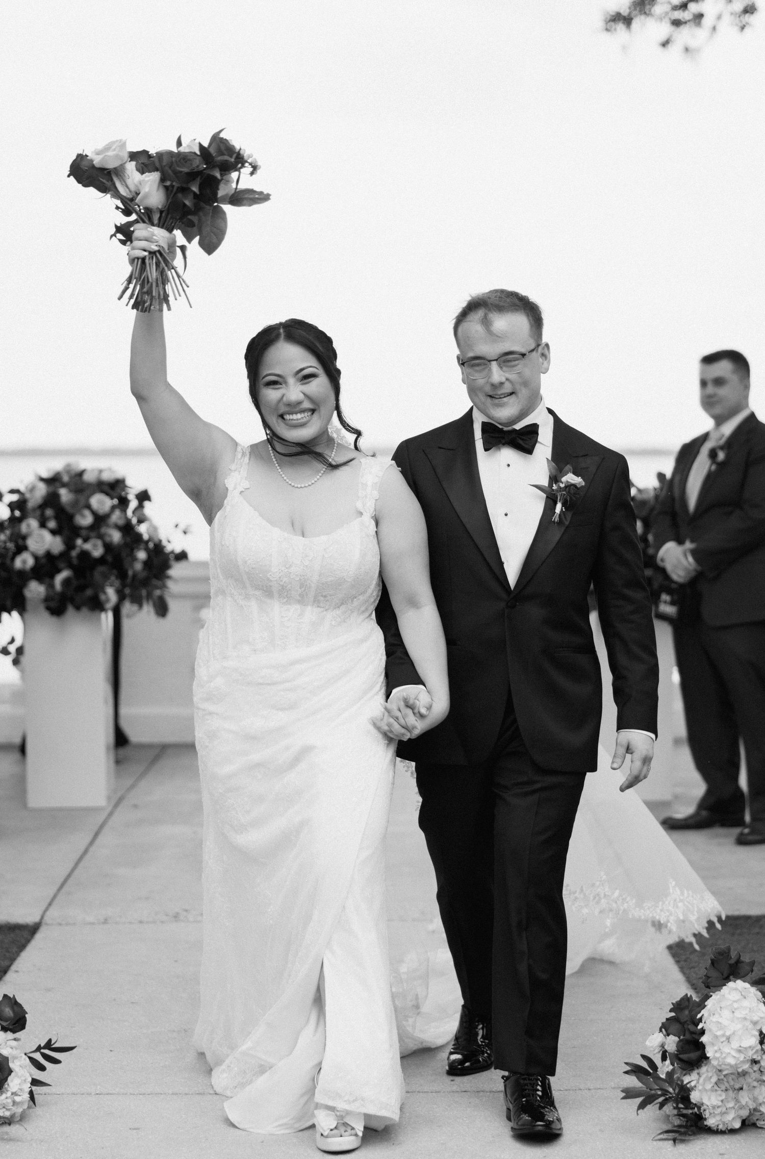 Wedding couple celebrates joyfully while walking together after their ceremony.