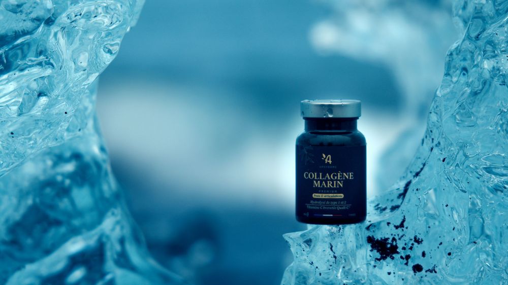 Luxury skincare bottles displayed against a backdrop of crystal clear blue ice formations and water splashes.