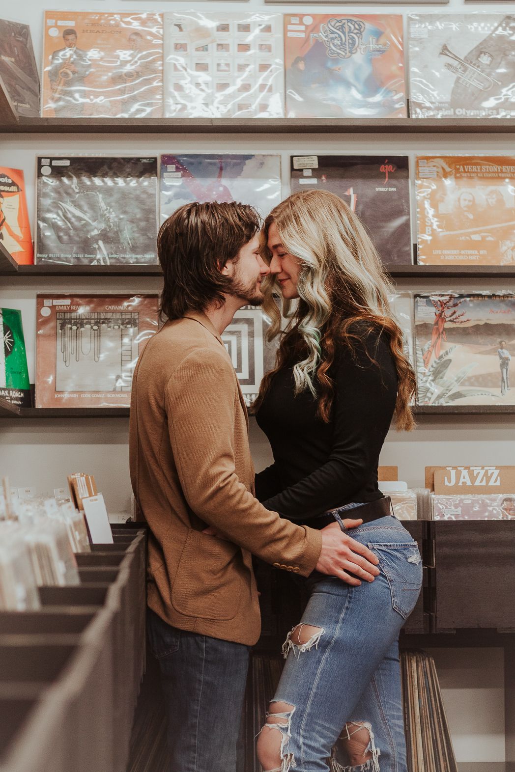 Candid moments of a couple at an arcade with vintage games in the background.