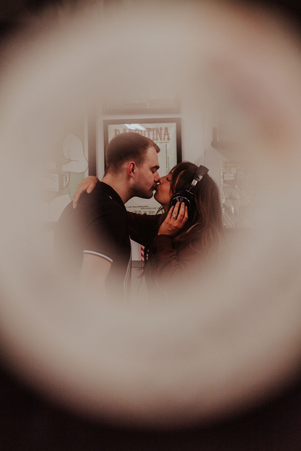 Intimate moment captured through dreamy vignette effect indoors.