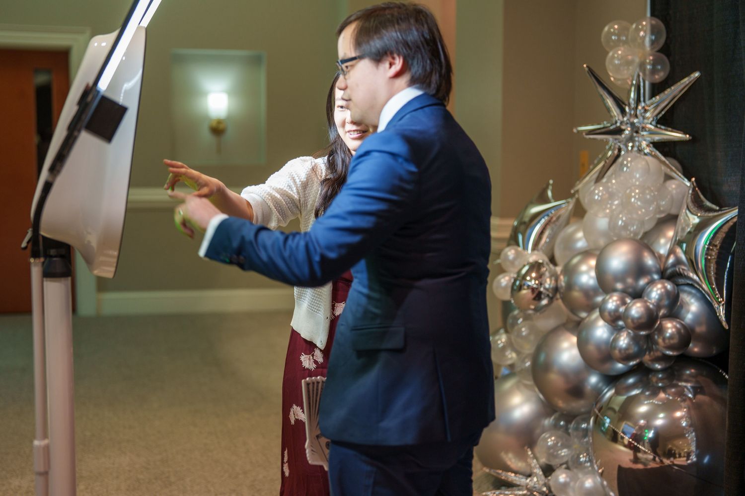 Interactive photo booth setup with illuminated ring light display.