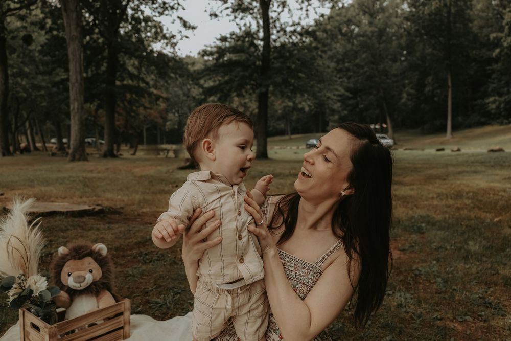 Candid family interactions captured near a peaceful lake surrounded by trees.