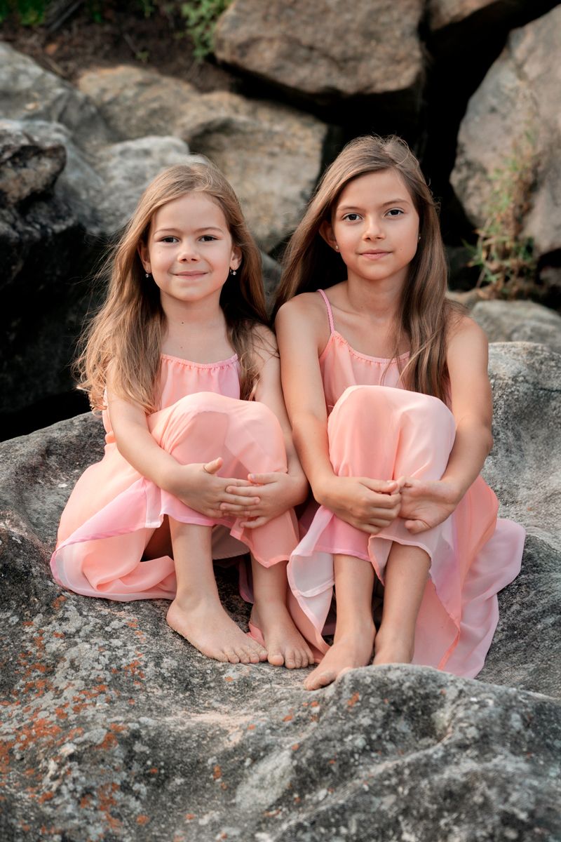 Sibling girls sitting on the rock at Freshwater during a family photoshoot in Sydney
