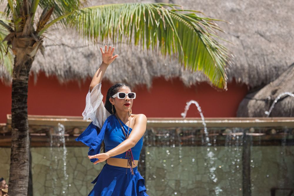 Tropical resort setting with palm trees and decorative elements.