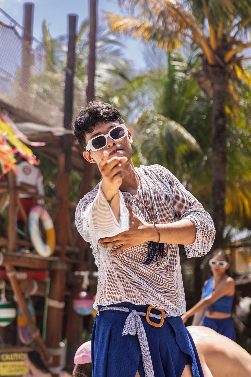 Playful dance movements captured in a tropical resort setting.