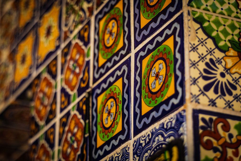 Detailed view of colorful Mexican ceramic tiles with intricate geometric patterns.