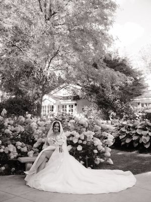 A panoramic black and white wedding photo series showing a bride in a flowing gown amid blooming hydrangea gardens.