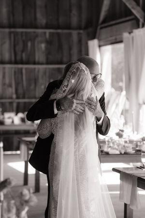 A black and white photo series showing intimate moments of a couple embracing during their wedding ceremony.