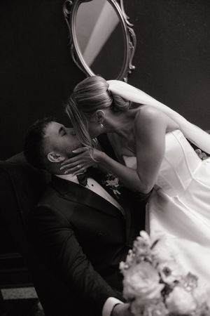 A romantic black and white photo series showing a couple in wedding attire sharing intimate moments.