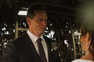 An emotional moment captured during an outdoor wedding ceremony.