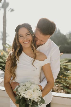 Intimate outdoor couples photoshoot with white roses and warm lighting.