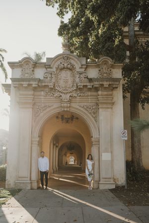 White stone archway with ornate architectural details and columns at a historic building.