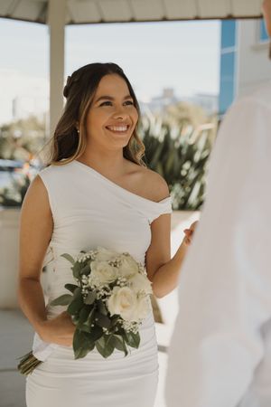 Beautiful outdoor bridal portraits featuring a white dress and floral bouquet.