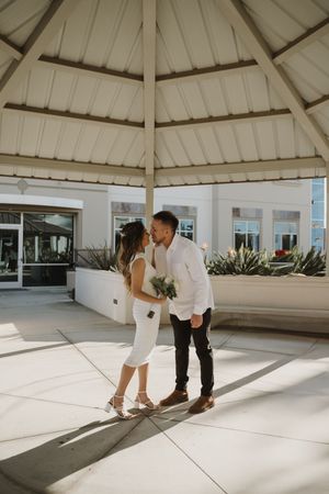 A romantic photo sequence under a white gazebo with natural lighting.