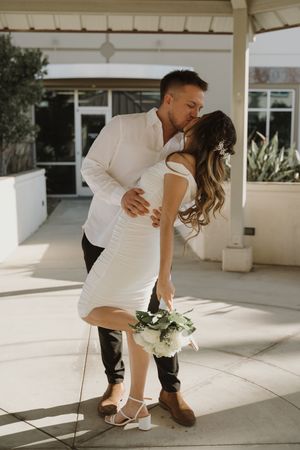 Series of romantic dip poses under a covered outdoor walkway.