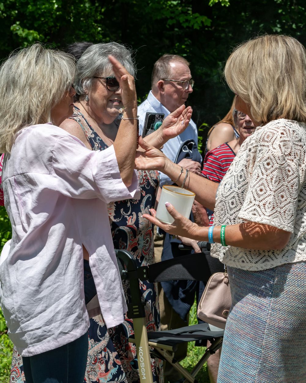 People interact outdoors during what appears to be a social gathering or event.