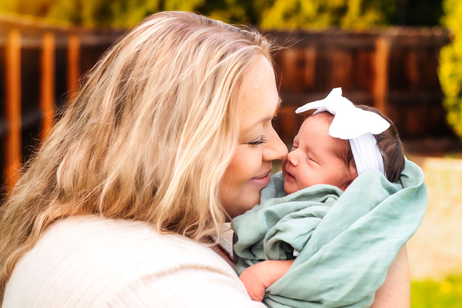 Mom kisses newborn baby daughter Newborn Photography Ellensburg, WA
