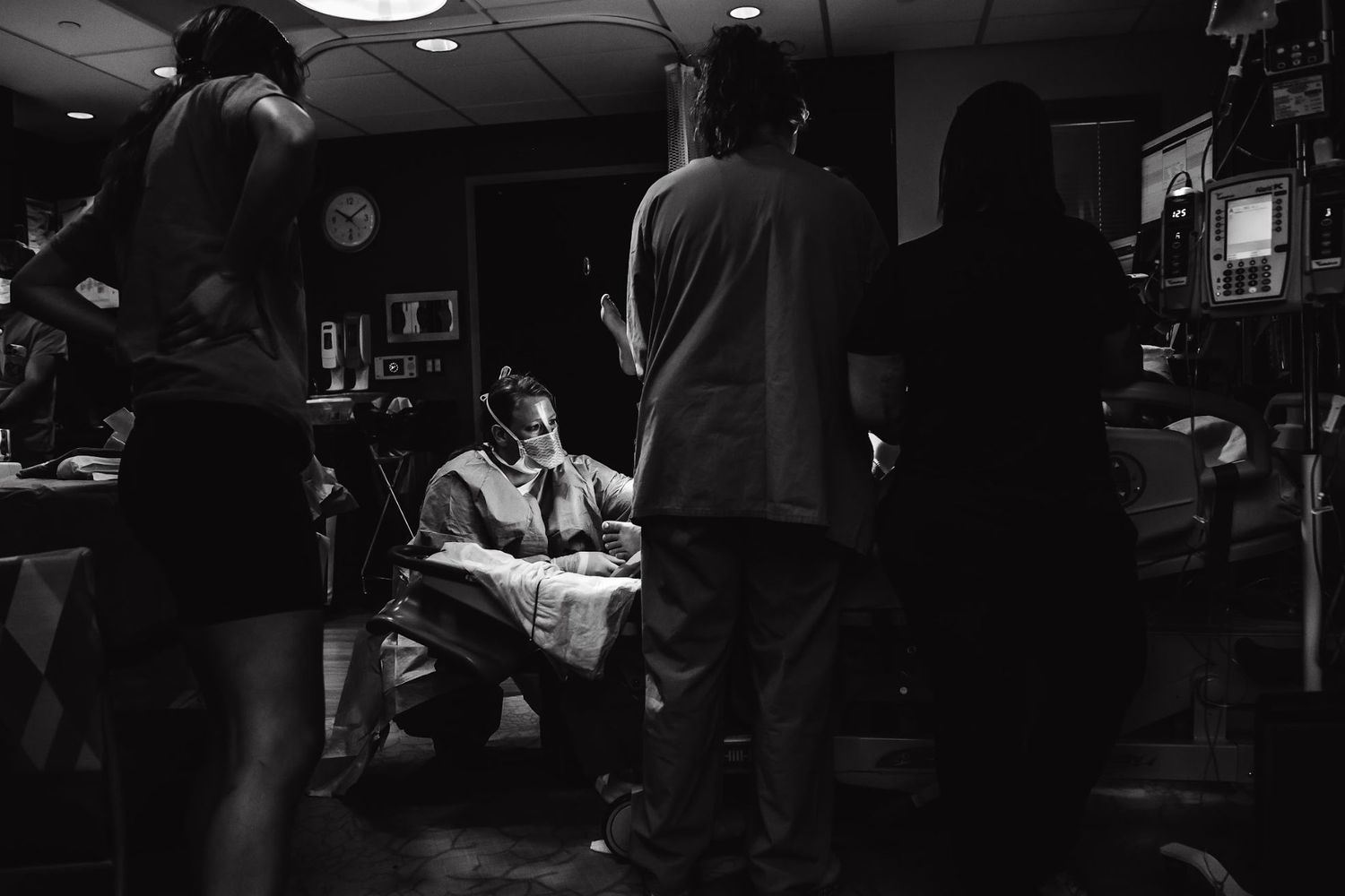 Dimly lit documentary photo of hospital staff during labor