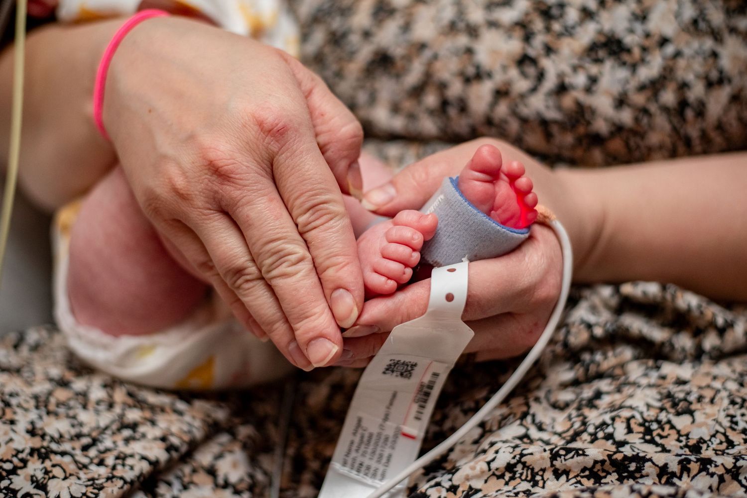 A series of hands holding and checking medical test strips against a speckled granite countertop background.