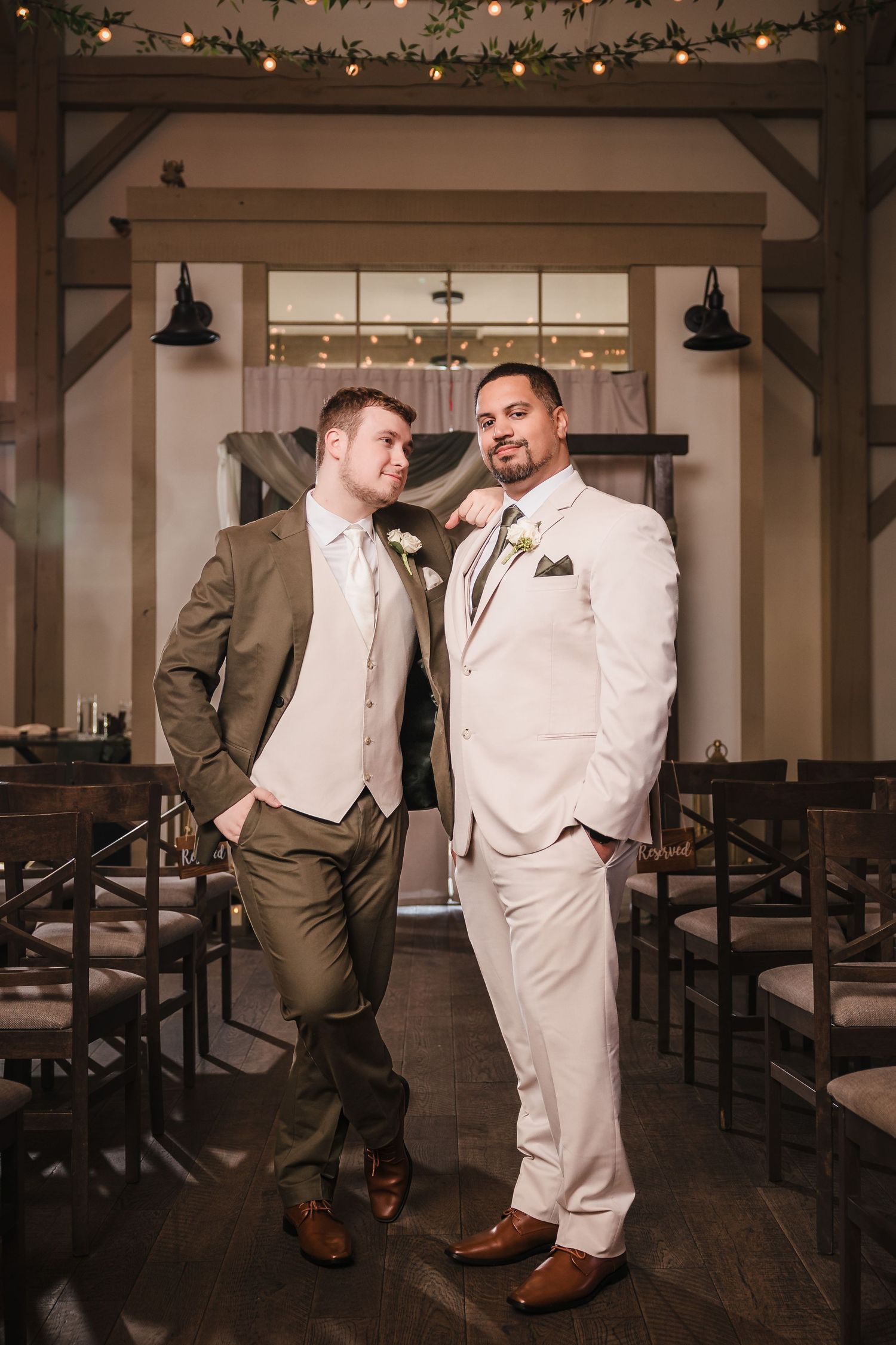Grooms formal portrait inside ceremony space at Briar Barn Inn wedding in Massachusetts with rustic barn details and string lights