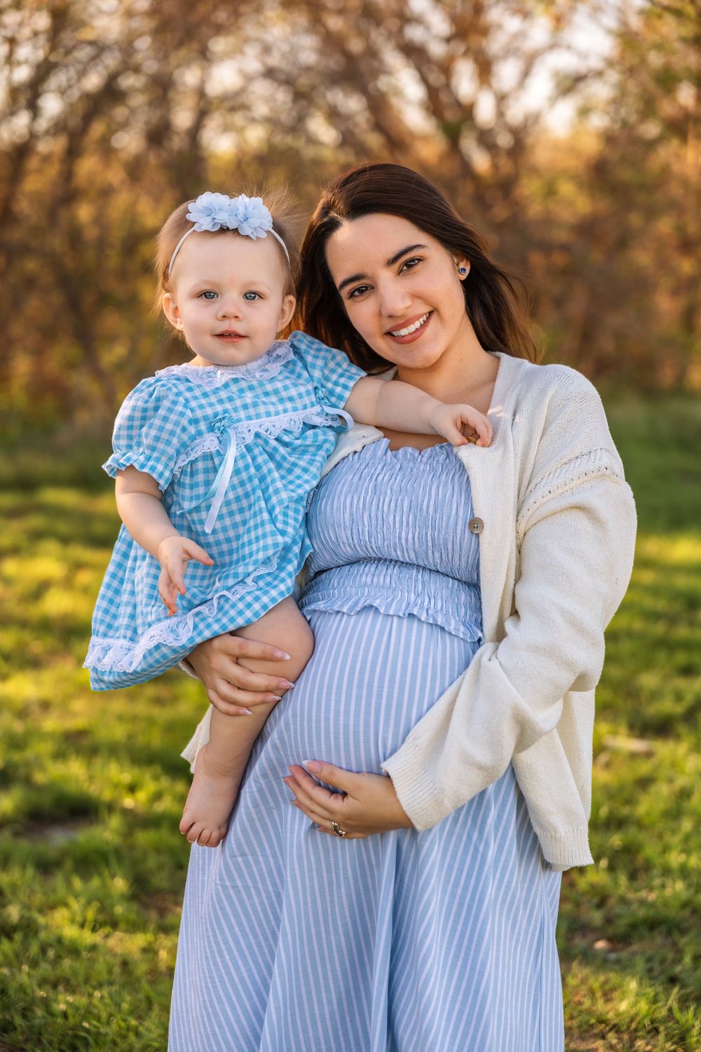 A warm motherhood session portrait of a mother holding her daughter while showcasing a refined, natural photography style.