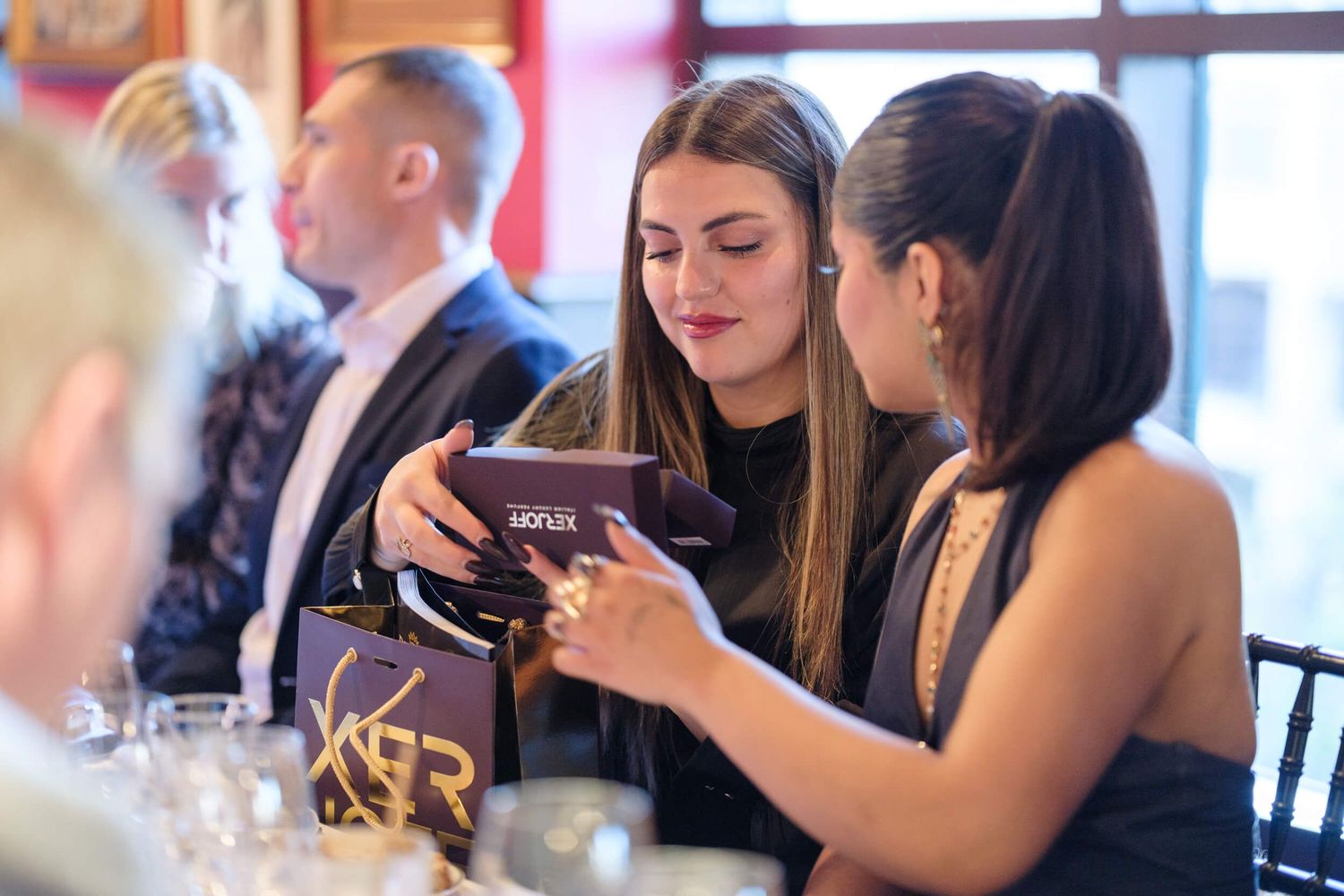 Diverse group of people engaged in animated conversation at a social gathering.