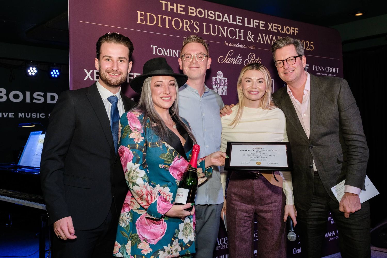 Group of attendees pose together at an awards ceremony with Boisdale branding in the background.