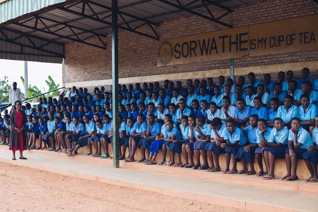 Students gather in uniform for a school assembly supporting education, community development and learning.